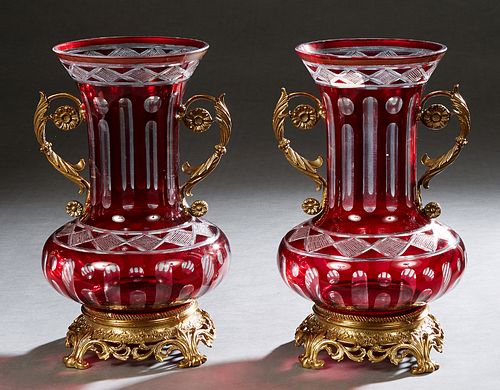 Pair of Brass Ormolu Mounted Ruby Cut-to-Clear Glass Baluster Vases, 20th/21st c., the everted neck over scrolled handles, on a pierced circular leaf 