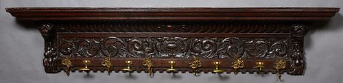 French Carved Oak Renaissance Style Coat Rack, late 19th c., the stepped crown for hats on lion carved supports flanking a hippocampus carved frieze a