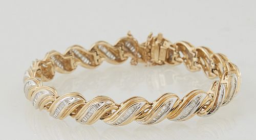 Vintage 18K Yellow Gold Flexible Link Bracelet, each of the 20 swirled links with a central conforming row of nine graduated baguette diamonds, with a