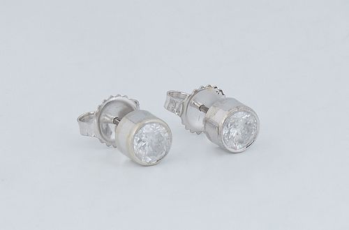 Pair of 14K White Gold Diamond Stud Earrings, each with a .5 ct. channel set round diamond, total diamond wt.- 1 ct., with appraisal.