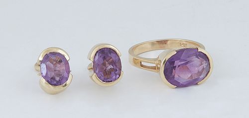 Vintage Three Piece Set of 14K Yellow Gold Jewelry, consisting of a ring with a horizontal mounted oval 3 ct. amethyst, Size 6, and a pair of clip ear