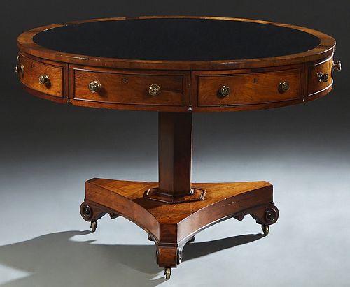 William IV Rosewood Rent Table, early 19th c., the banded circular top with inset tooled leather, over a skirt with four drawers and four faux drawers