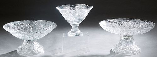 Group of Three Pieces of Cut Glass, 20th/21st c., consisting of two scalloped circular bowls on circular bases, and a taller scalloped top bowl on a s