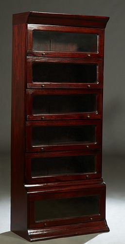 Carved Mahogany Barrister Style Bookcase, 20th c., the ogee crown over six shelves with lifting glazed doors, H.- 75 in., W.- 31 3/4 in., D.- 16 in.