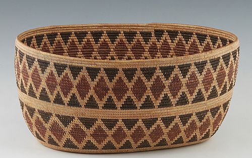 Southwestern Native American Open Oval Basket, 20th c., possibly Apache, with a tri-color diamond banded design, woven with dried willow and cottonwoo