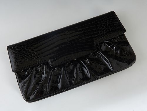 Vintage Judith Leiber Black Patent Leather Faux Alligator Clutch, with gold hardware and a push latch closure, the interior of the bag lined in a blac