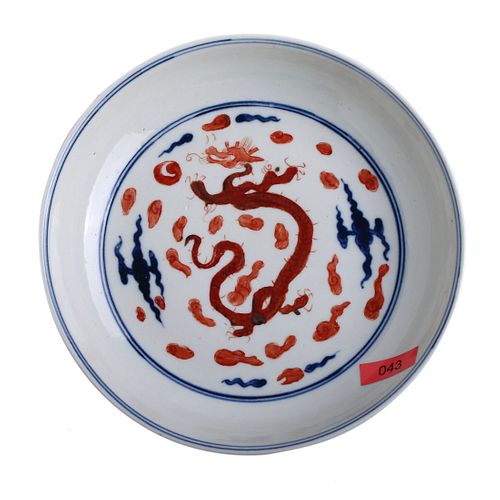A CHINESE BLUE AND WHITE AND COPPER RED DRAGON DISH