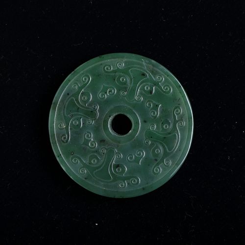 A GREEN JADE DISC WITH 'GRAIN' PATTERN