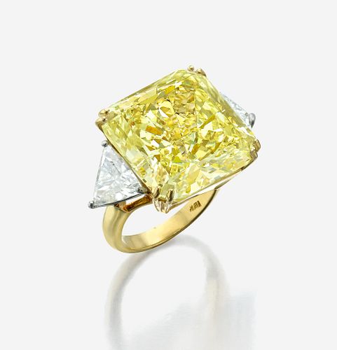 An impressive fancy light yellow diamond ring
