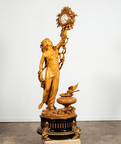 WELL CARVED MONUMENTAL MAIDEN FIGURE WITH CLOCK