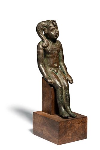 An Egyptian Bronze Harpocrates
Height 4 7/8 inches. 