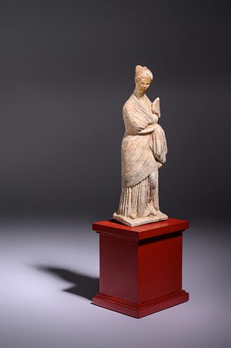A Greek Terracotta Female with a Fan
Height 8 inches. 