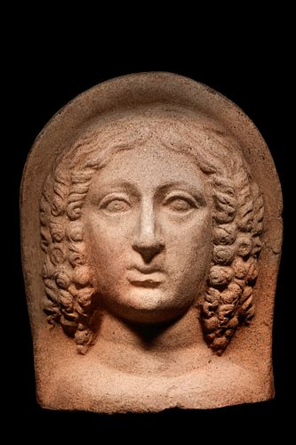 An Etruscan Terracotta Votive Head of a Woman
Height 10 1/4 inches.