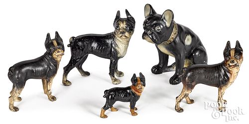 Four painted cast iron dog doorstops, and another