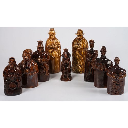 Nine Figural Flasks in Brown Glaze
