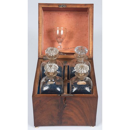 A Tantalus with Four Decanters and Glass