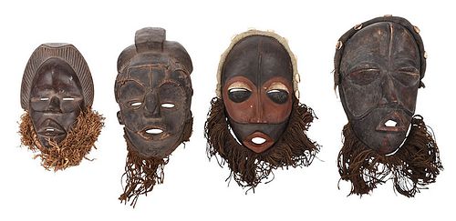Four West African Carved Wood and Fiber Masks