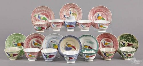 Eleven spatter cups and saucers with peafowl de