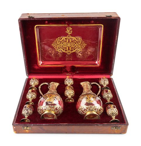 A French Silver Gilt and Crystal Decanter Set
Height of decanter 8 1/2 inches; length of tray 11 1/2 inches.