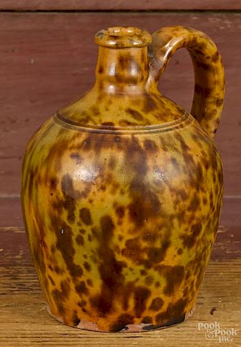Small redware jug, 19th c., with mottled orange