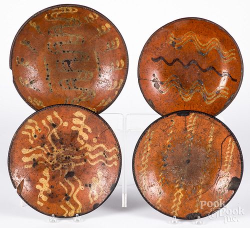 Four redware chargers, 19th c.