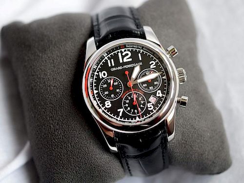 Featuring a stainless steel case, black dial with date aperture between 4 and 5. Offered on a black