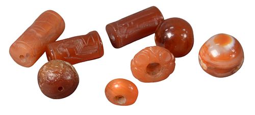 Group of Eight Early Carved Carnelian Seals and Beads, having engraved busts, winged horse, along with Victoria in profile to the left, largest 1 inch