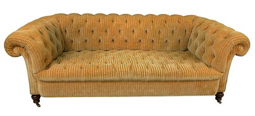 Tufted Upholstered Sofa, on brass castors, length 87 inches.