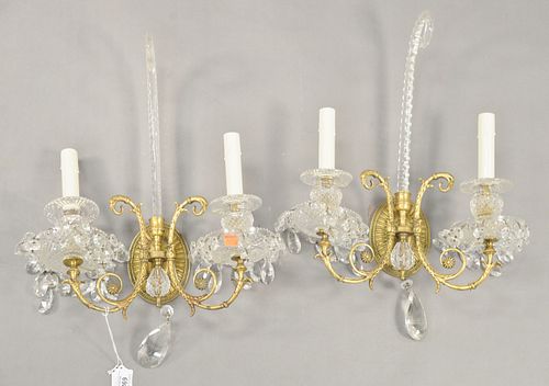 Pair of English Gilt Bronze and Crystal Two Light Wall Sconces having scrolling crystal top, height 20 inches, width 12 inches.