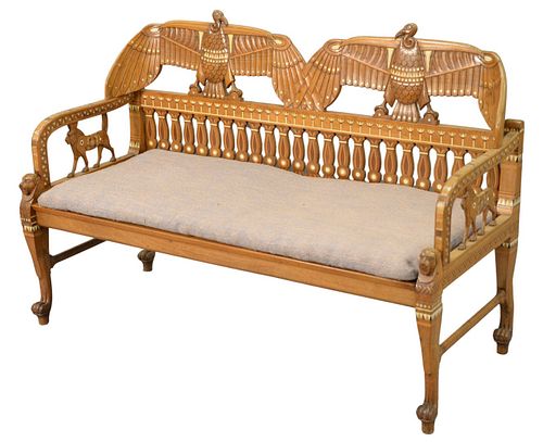 Egyptian Revival Settee, having carved inlaid birds, lion arm supports, and animal head legs ending in paw feet, with a woven seat and custom cushion,