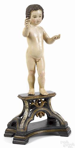 Continental carved and polychrome painted putti on a stand, 18th/19th c., retaining an old surface