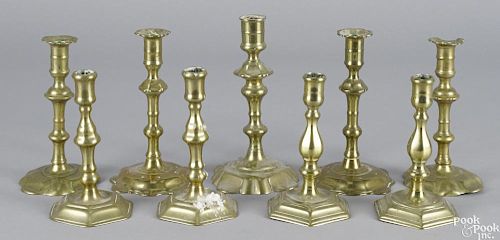 Four pairs of English brass candlesticks, 18th c., together with a single petal base stick