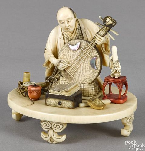 Japanese Meiji period carved ivory musician with abalone appliqués, 3 1/4'' h., 3 3/4'' w.