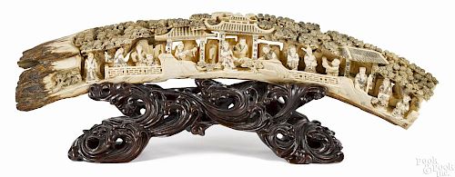 Chinese carved mammoth tusk decorated with scholars and figures in a landscape, 24'' l.
