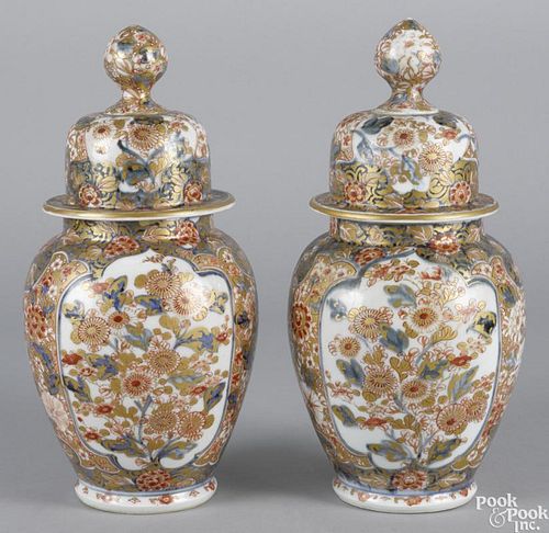 Pair of Japanese Imari palette porcelain urns, 19th c., with covers, 13 1/4'' h.