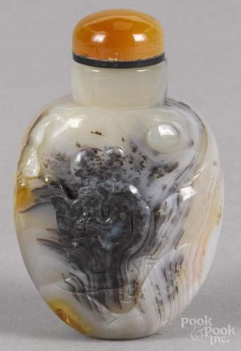 Chinese carved agate snuff bottle decorated with a seated deity, 2 3/4'' h.
