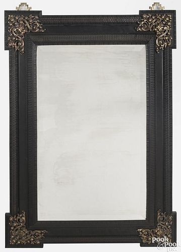 Continental ebonized mirror, late 18th c., with applied brass floral appliqués, 55 1/2'' x 39 1/4''.