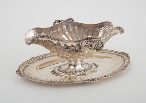 FRENCH SILVER DOUBLE SPOUTED SAUCE BOAT AND ATTACHED STAND, IN THE LOUIS XV STYLE