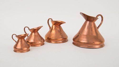 FOUR ENGLISH COPPER FUNNEL-SHAPE IMPERIAL MEASURE PITCHERS