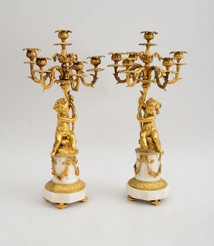PAIR OF LOUIS XVI STYLE GILT-BRONZE AND WHITE MARBLE FIGURAL SIX-LIGHT CANDELABRA