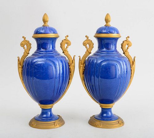 PAIR OF LOUIS XVI STYLE GILT-METAL-MOUNTED SÈVRES STYLE BLUE-GLAZED POTTERY URNS AND COVERS