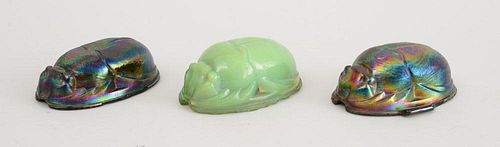 TWO LETZ TYPE IRIDESCENT PRESSED GLASS SCARAB-FORM PAPERWEIGHTS AND A SIMILAR GREEN GLASS WEIGHT