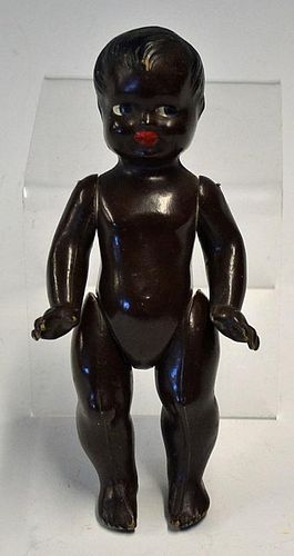 Composite black Doll having moving hands and arms with painted eyes and lips 8 inches high