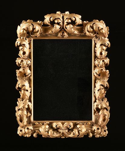 A GERMAN BAROQUE STYLE PARCEL GILT CARVED WOOD MIRROR, 19TH CENTURY, 