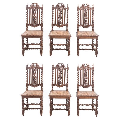 Lote de 6 sillas. Francia. SXX. Estilo Enrique II. En talla de madera de roble. Con respaldos semiabiertos, asientos de bejuco.