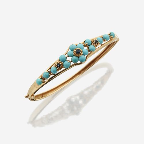 A fourteen karat gold, turquoise, and sapphire bangle