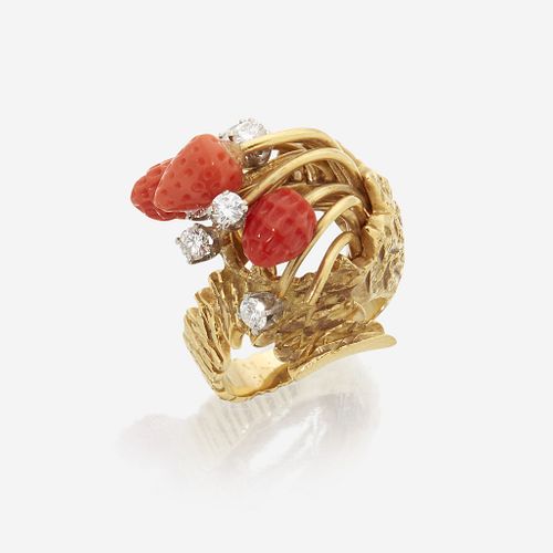 An eighteen karat gold, coral, and diamond ring