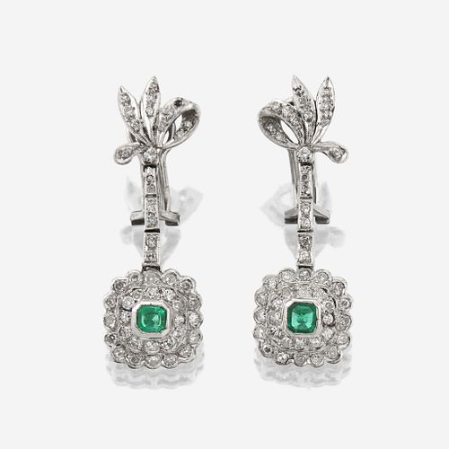 A pair of diamond, emerald, and fourteen karat white gold earrings