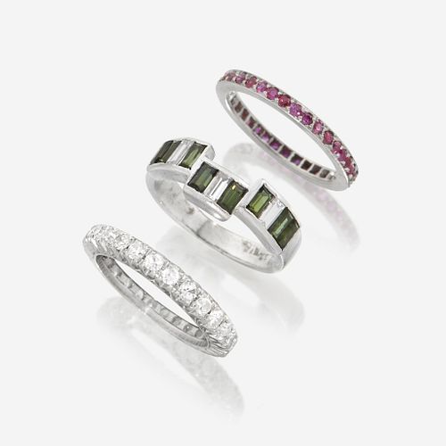 A collection of three platinum and gem-set bands