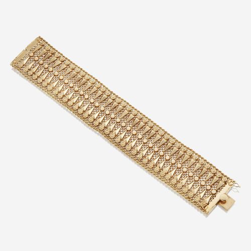An eighteen karat gold wide bracelet
